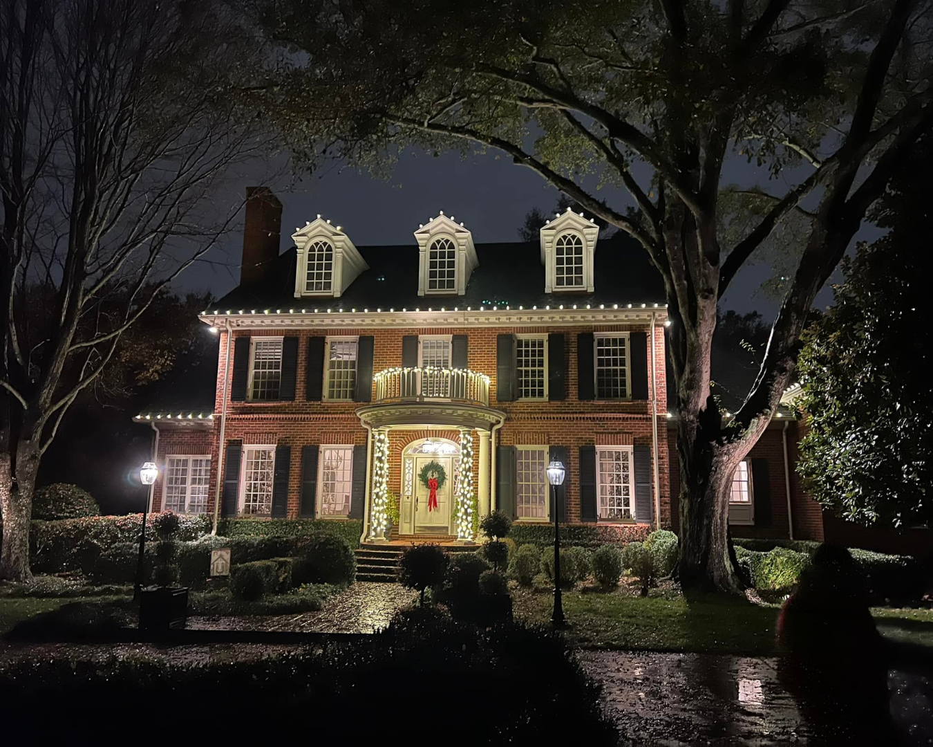 Beautiful residential, two story home, neatly lines with white Christmas lights.