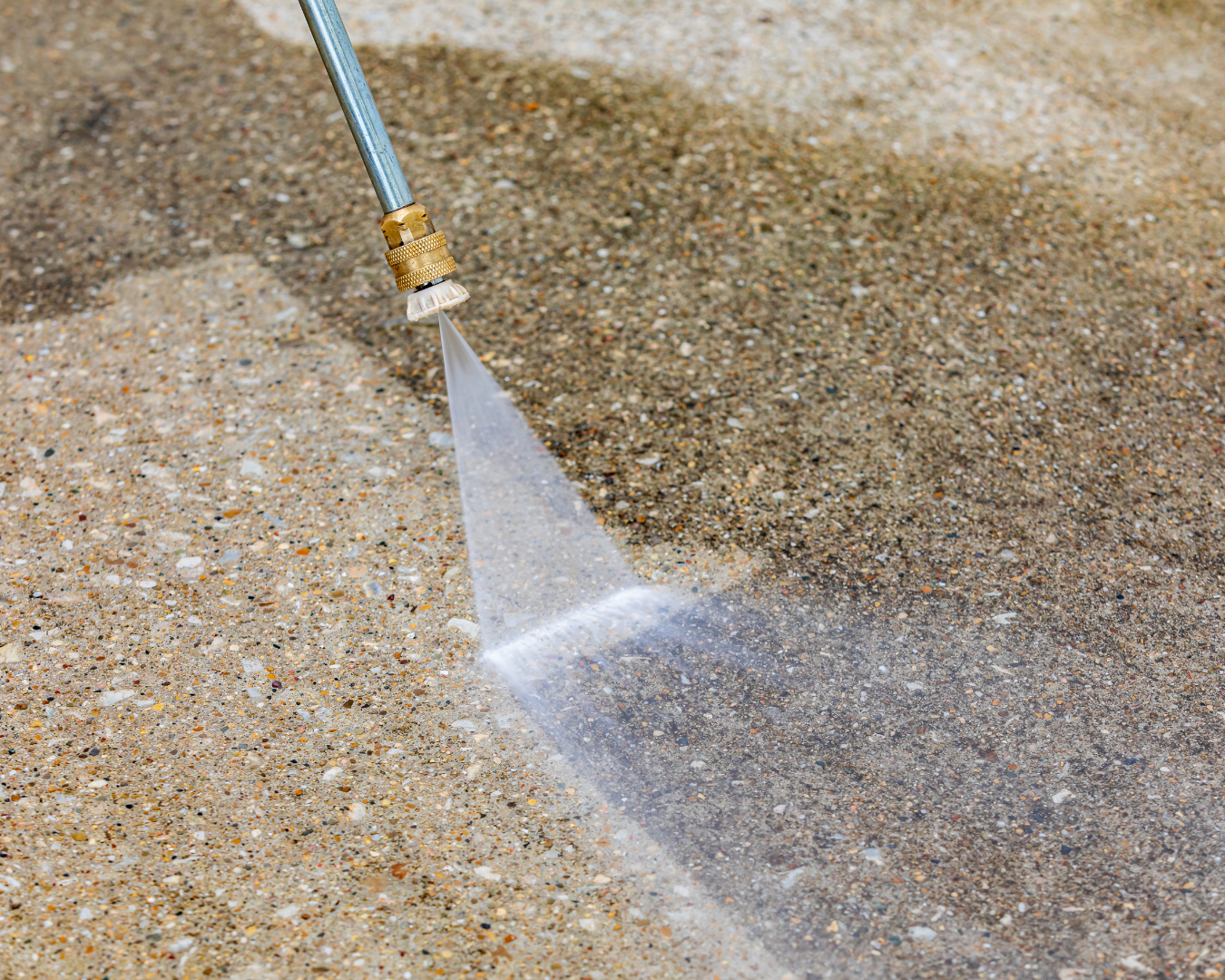 Close-up shot of driveway being powerwashed.